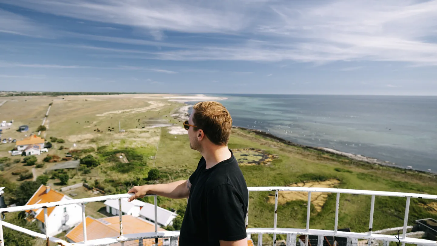 A man stands in the Långe Jan lighthouse and looks out over the southern tip of Öland