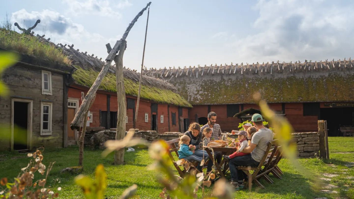Une famille prend un café dans une cour du musée Himmelsberga, sur l'île d'Öland.