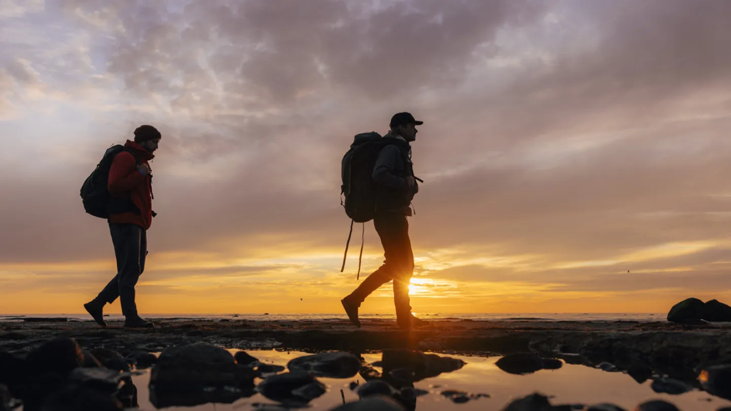 Två killar vandra på Öland i solnedgång